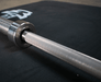 7' Stainless Steel Bushing Olympic Bar and Bumper Plate Set - Sweatfully